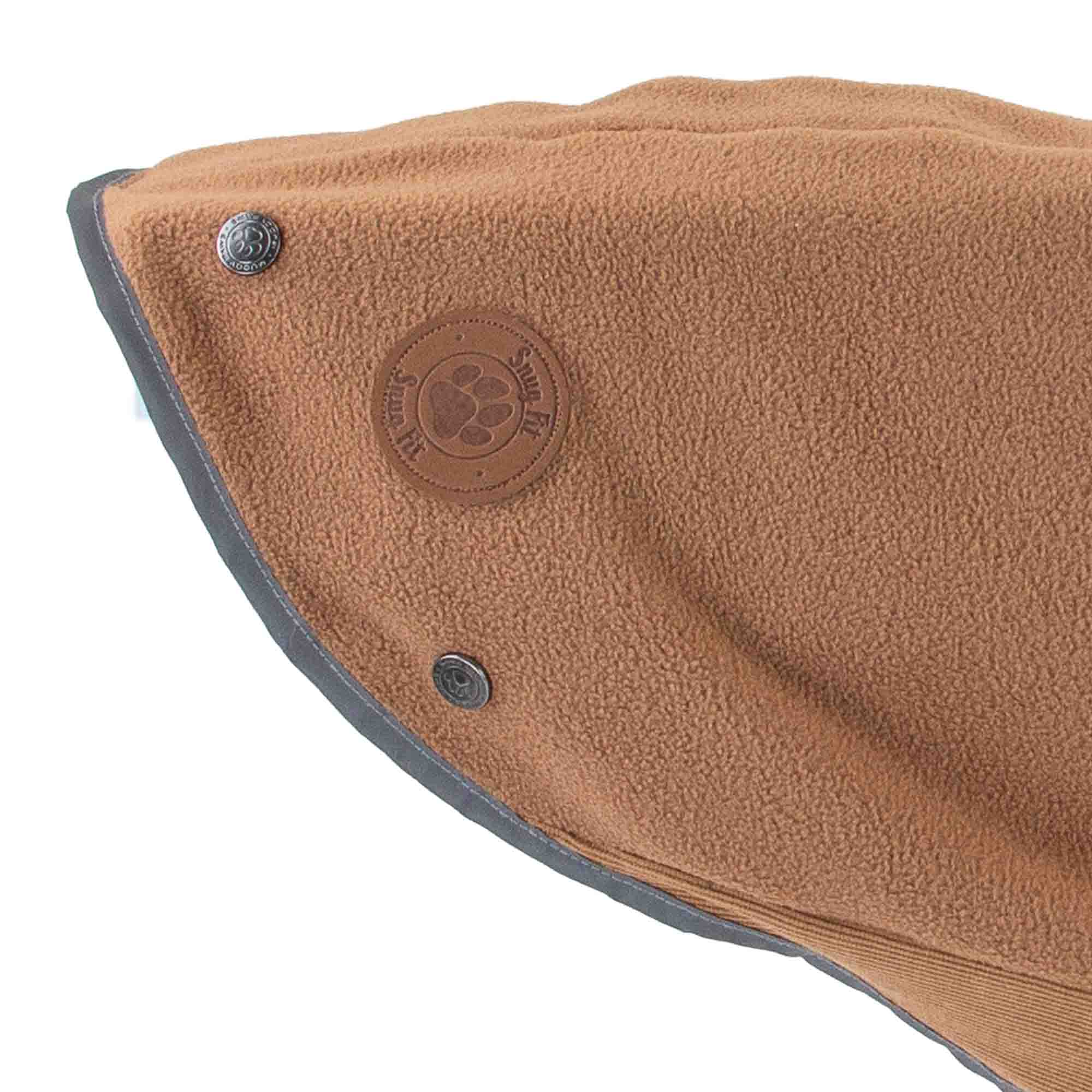 Detail of the camel Snug Fit fleece showing the badge and reflective edging