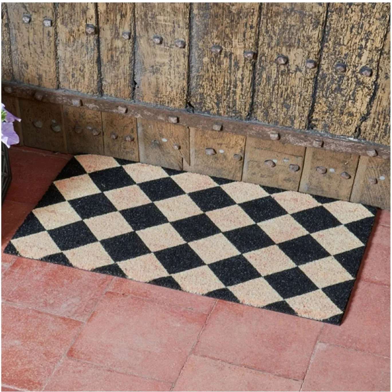 Checkered doormat on a stone floor with 'Buyaparcel' logo above.